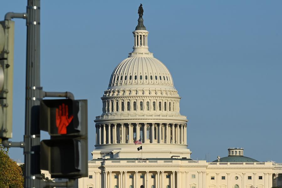 This photo taken on Oct. 21, 2025 shows the U.S. Capitol building behind a traffic light in Washington, D.C., the United States. (Photo: Xinhua)