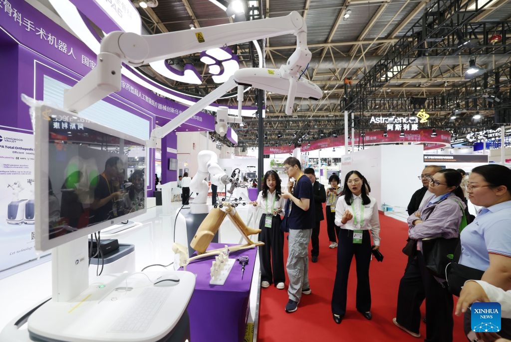 People learn about the AI-powered total orthopedic robotics platform in the Healthy Life exhibition area during the 4th China International Supply Chain Expo (CISCE) in Beijing, the capital of China, on June 23, 2026. The 4th CISCE will be held in Beijing from June 22nd to 26th. CISCE, which opens in 2023, is the world's first national-level exhibition focused on supply chains. Now in its fourth year, CISCE maintains a panoramic view of the industry chain, featuring six major chain and supply chain service exhibition areas. For the first time, the Digital Technology section also introduces a zone dedicated to Artificial Intelligence. (Photo: Xinhua)
