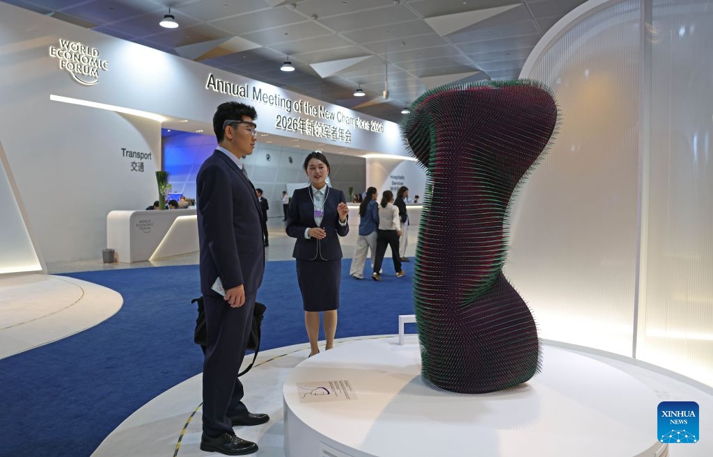 A participant interacts with an exhibit during the 17th Annual Meeting of the New Champions in Dalian, northeast China's Liaoning Province, on June 23, 2026. Scheduled from Tuesday to Thursday, the 2026 Summer Davos forum, officially known as the World Economic Forum's Annual Meeting of the New Champions, is expected to bring together over 1,700 participants from more than 90 countries and regions to explore how the world can navigate global challenges while creating new opportunities for growth. (Photo: Xinhua)