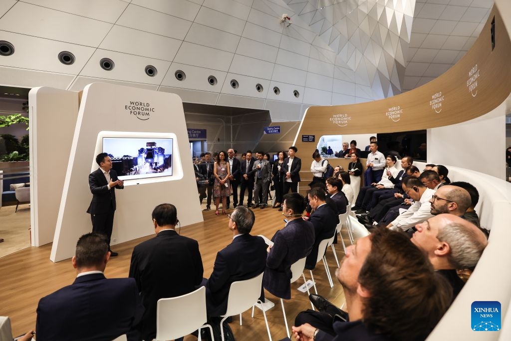 Participants attend a session titled EV Strategy Goes Robotic during the 17th Annual Meeting of the New Champions, also known as the Summer Davos, at the Dalian International Conference Center in Dalian, northeast China's Liaoning Province, June 24, 2026. Featuring the theme Innovating at Scale, the event is held from June 23 to 25. Over 30 subjects related to artificial intelligence and robotics are among the hot topics at this year's forum. (Photo: Xinhua)