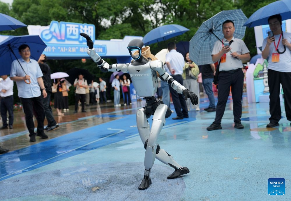 A robot developed by Unitree Robotics performs dancing during an AI exhibition by the West Lake in Hangzhou, east China's Zhejiang Province, June 24, 2026. New applications of artificial intelligence and embodied intelligence in the cultural and tourism sector from 15 leading technology companies were displayed at the exhibition. (Photo: Xinhua)