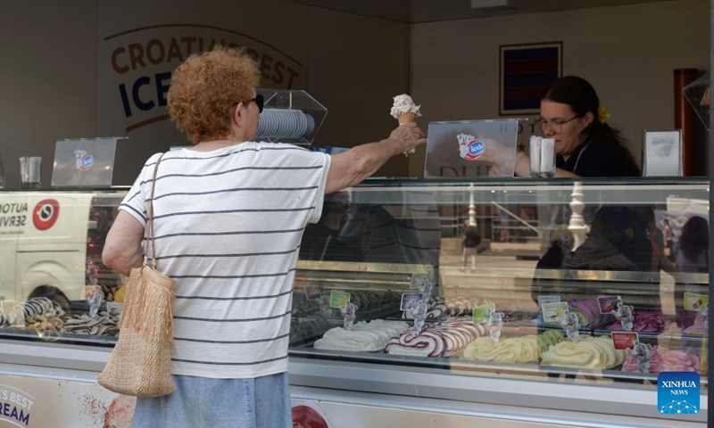 A woman buys an ice cream amid a heatwave in Zagreb, Croatia, June 24, 2026. (Photo: Xinhua)