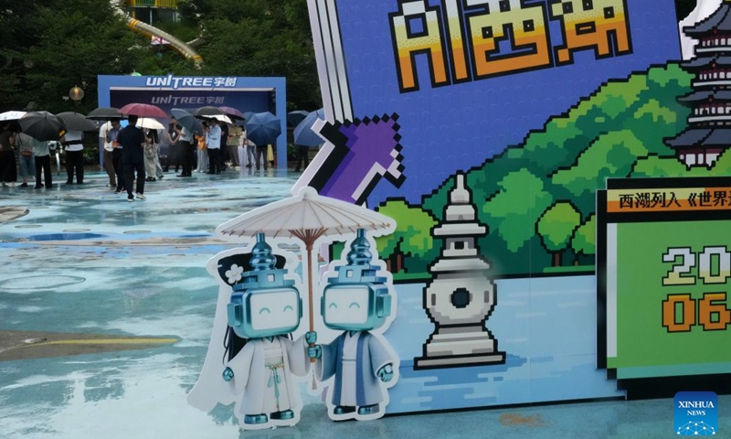 Audience visit the booth of Unitree during an AI exhibition by the West Lake in Hangzhou, east China's Zhejiang Province, June 24, 2026. New applications of artificial intelligence and embodied intelligence in the cultural and tourism sector from 15 leading technology companies were displayed at the exhibition. (Photo: Xinhua)