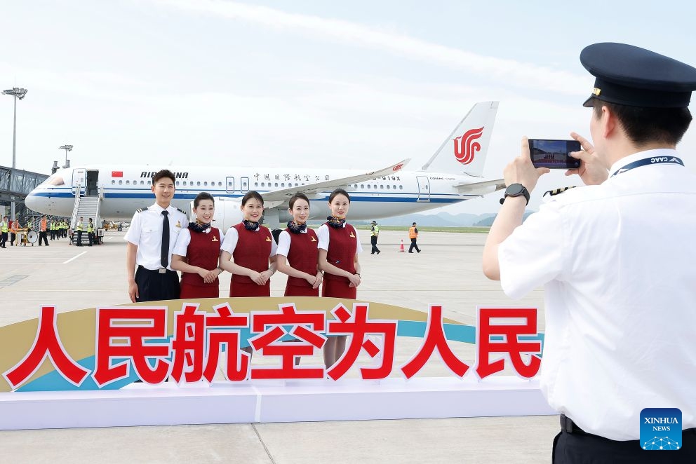Crew members of CA1279 of Air China pose for a group photo after arriving at the Nanniwan Airport in Yan'an, northwest China's Shaanxi Province, on June 24, 2026. Air China on Wednesday started using China's domestically-produced C919 jetliner on a new route linking Beijing with Yan'an of northwest China's Shaanxi Province. By far, Air China has opened a dozen of air routes from Beijing to old revolutionary base areas such as Jinggangshan, Zunyi and Yan'an, planning to offer 260 flights every week, to inject impetus into the development of these areas. (Photo: Xinhua)