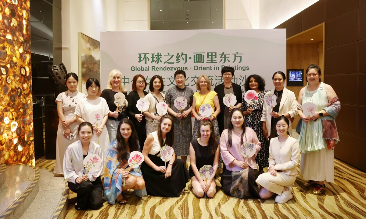 Guests attending the event pose for a group photo in Beijing on June 18, 2026.