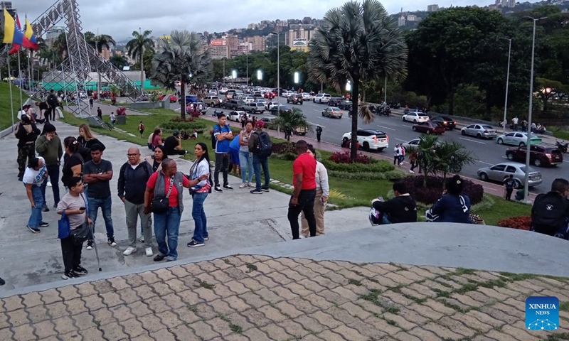 This photo taken with a mobile phone shows people gathering in an open space after an earthquake in Caracas, Venezuela, June 24, 2026. Two powerful earthquakes struck Venezuela in quick succession on Wednesday evening, both causing strong tremors in the capital of Caracas. (Photo: Xinhua)