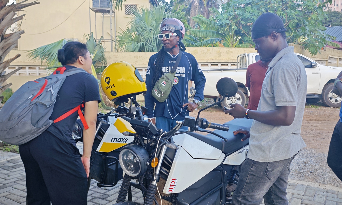 Consumers in Ghana test ride the TK90 electric motorcycle. Photo: Courtesy of TAILG