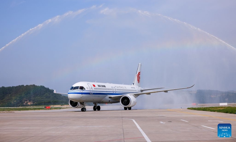 The flight CA1279 of Air China receives a water salute after arriving at the Nanniwan Airport in Yan'an, northwest China's Shaanxi Province, on June 24, 2026. Air China on Wednesday started using China's domestically-produced C919 jetliner on a new route linking Beijing with Yan'an of northwest China's Shaanxi Province. By far, Air China has opened a dozen of air routes from Beijing to old revolutionary base areas such as Jinggangshan, Zunyi and Yan'an, planning to offer 260 flights every week, to inject impetus into the development of these areas. (Photo: Xinhua)
