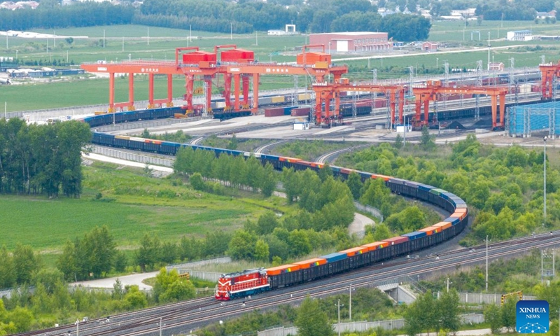 A drone photo taken on June 24, 2026 shows a China-Europe freight train arriving at a yard of transshipment operation of Tongjiang North Railway Station in Tongjiang, northeast China's Heilongjiang Province. By June 23, Tongjiang railway port has handled 128 China-Europe freight train trips with 115,724 tonnes of goods, increasing by over 100 percent year on year. (Photo: Xinhua)