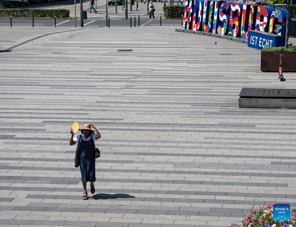 A woman walks in the sunshine in Duisburg, Germany, June 24, 2026. Germany has been experiencing a heatwave in recent days, with temperatures approaching 40 degrees Celsius in some regions. (Photo: Xinhua)