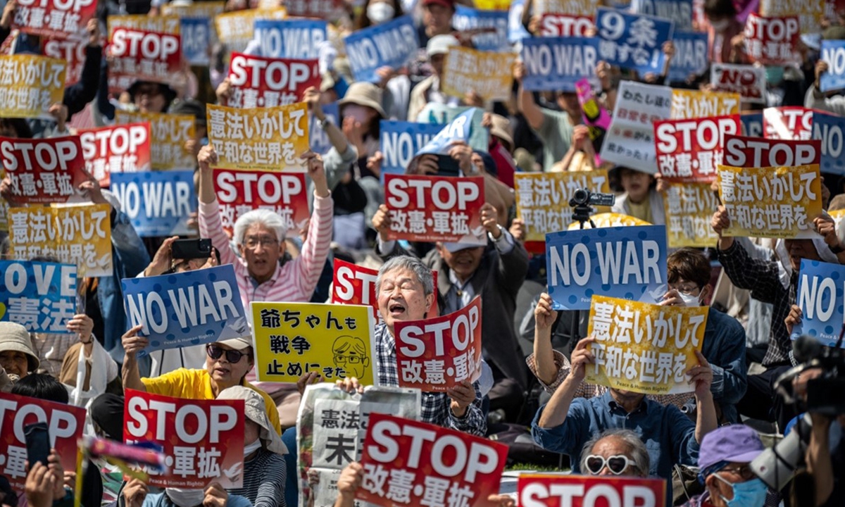 People hold placards reading 