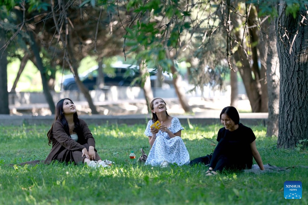 People relax under the trees in Bishkek, Kyrgyzstan, June 25, 2026. (Photo by Roman/Xinhua)