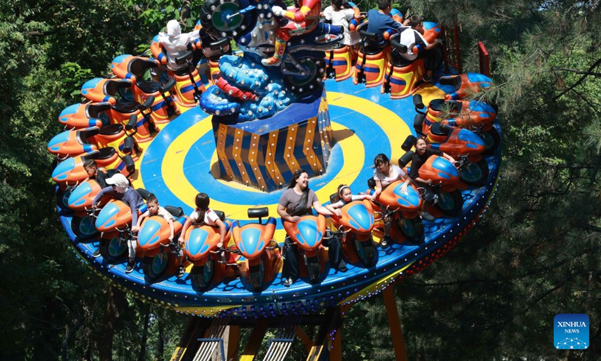 People have fun at an amusement park in Bishkek, Kyrgyzstan, June 25, 2026. (Photo by Roman/Xinhua)