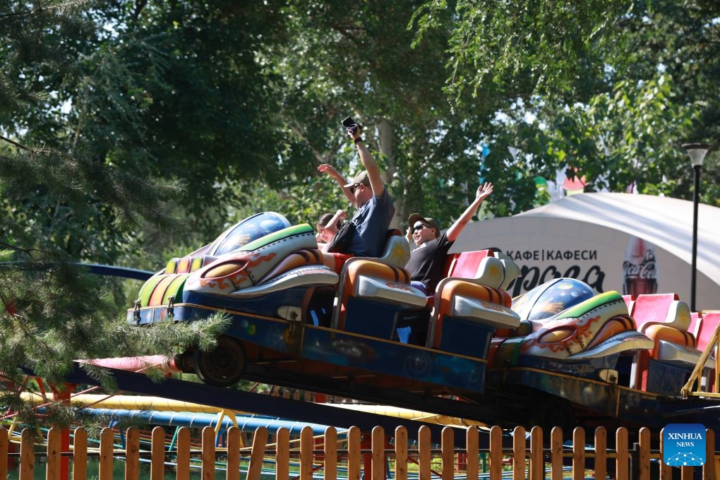 People have fun at an amusement park in Bishkek, Kyrgyzstan, June 25, 2026. (Photo by Roman/Xinhua)