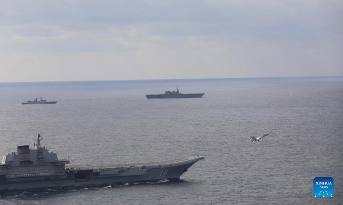 Undated file photo shows the Chinese navy's Liaoning aircraft-carrier formation conducting open-sea combat training. Photo:Xinhua