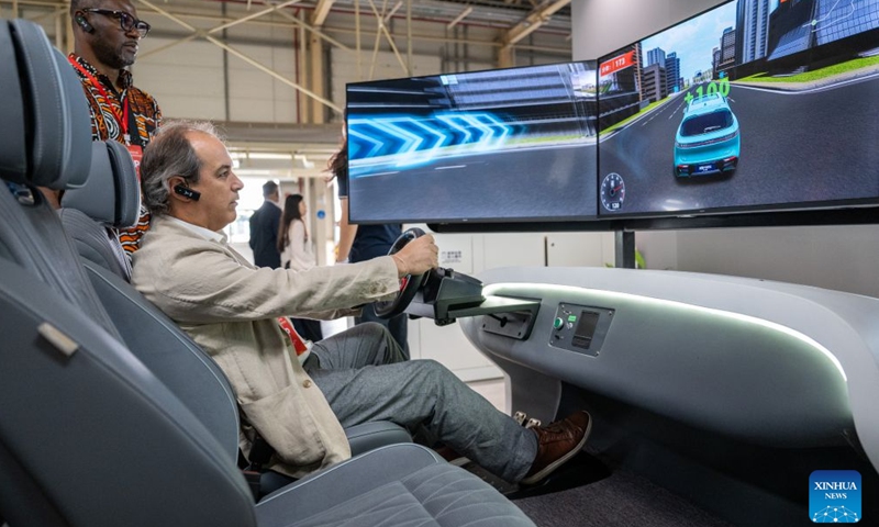 A foreign diplomatic envoy experiences a simulated cockpit at Voyah's automobile plant in Wuhan, central China's Hubei Province, June 25, 2026.

