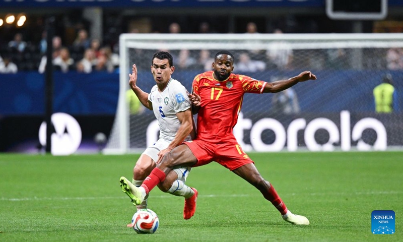 Rustam Ashurmatov (L) of Uzbekistan vies with Cedric Bakambu of the Democratic Republic of the Congo (DRC) during the group K match between the Democratic Republic of the Congo and Uzbekistan at the 2026 FIFA World Cup at Atlanta Stadium in Atlanta, the United States, June 27, 2026. (Xinhua/Ju Huanzong)

