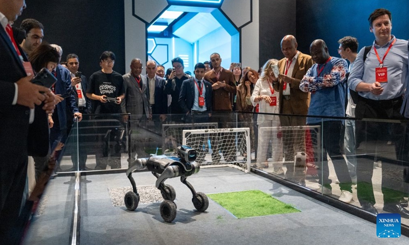 Foreign diplomatic envoys watch a robot dog performance in an immersive exhibition in Wuhan, central China's Hubei Province, June 24, 2026.

