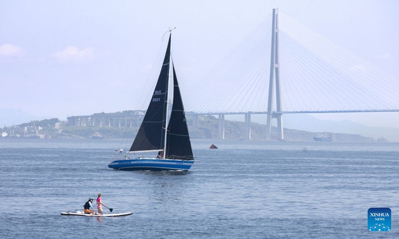 People enjoy water sports in Vladivostok, Russia, June 27, 2026. As temperature in Vladivostok rises significantly, people have flocked to the streets and the seaside to enjoy their summer time. (Photo by Andrey Matveenko/Xinhua)


