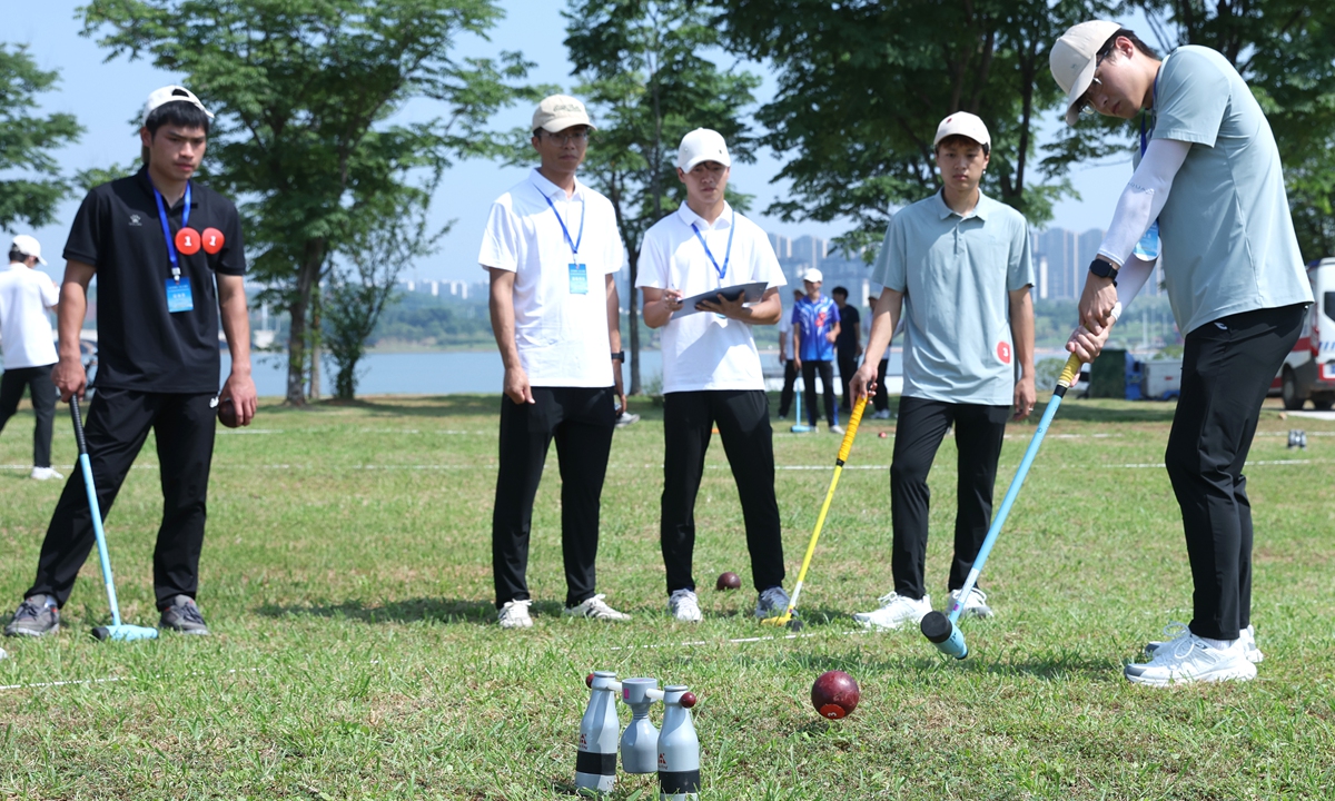 A student (right) plays woodball on June 28, 2026 at the 2nd cross-Straits youth woodball exchange event in Nanchang, East China's Jiangxi Province, which drew over 100 young participants from Jiangxi Province and the Taiwan region. Inspired by golf-based stroke play, woodball can be played individually or in teams using wooden mallets to hit a wooden ball through narrow gates. Photo: CNS Photo