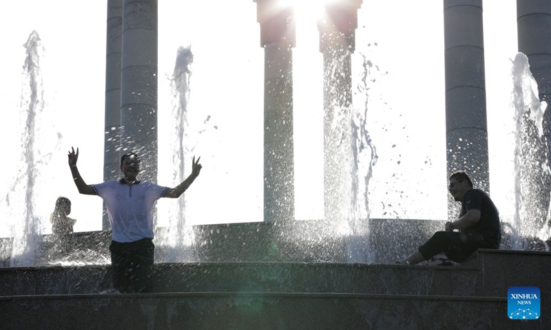 People cool off at a fountain amid a heatwave in Tashkent, Uzbekistan, June 27, 2026. (Photo by Zafar Khalilov/Xinhua)

