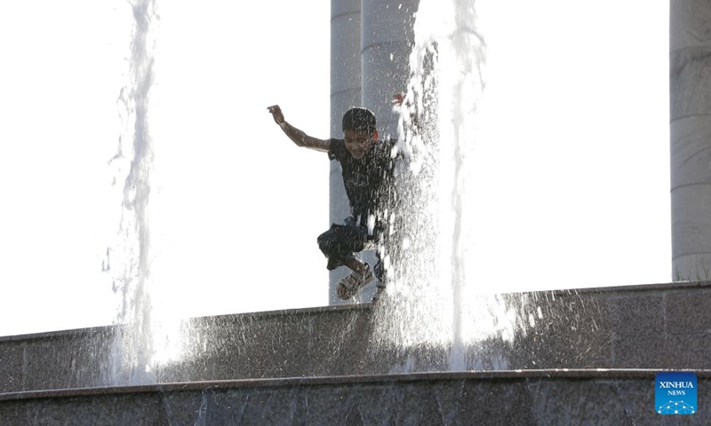 A boy cools off at a fountain amid a heatwave in Tashkent, Uzbekistan, June 27, 2026. (Photo by Zafar Khalilov/Xinhua)

