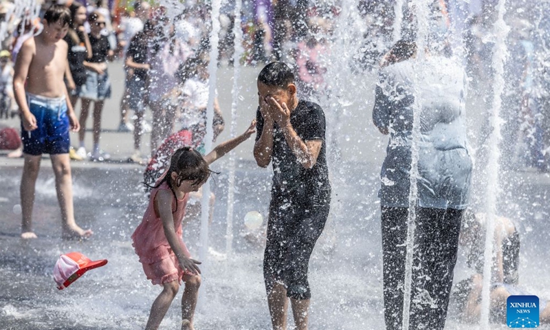 People cool off in the fountain in Vladivostok, Russia, June 27, 2026. As temperature in Vladivostok rises significantly, people have flocked to the streets and the seaside to enjoy their summer time. (Photo by Andrey Matveenko/Xinhua)

