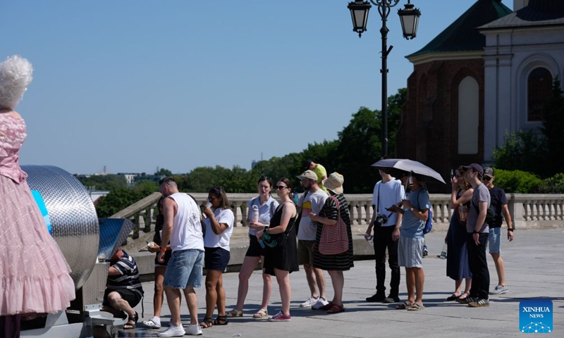 Residents queue at a public water distribution point near the Royal Castle Square in Warsaw, Poland, June 27, 2026. Poland's Institute of Meteorology and Water Management has issued its highest, third-level heat warnings from Saturday morning to Monday evening.

