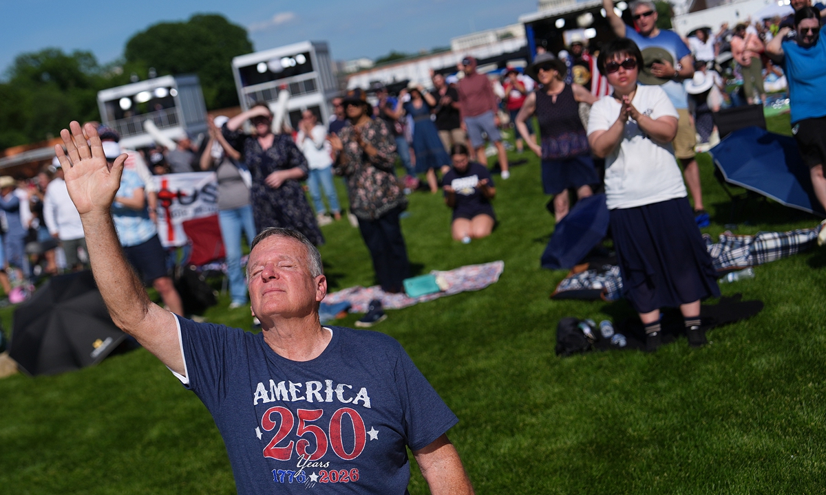 A man kneels in prayer during the Rededicate 250 gathering on the National Mall in Washington, DC, on May 17, 2026. Photos on this page: VCG 