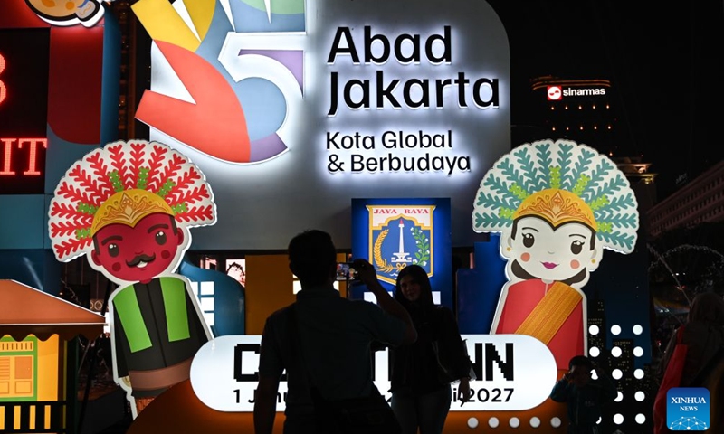 People take photos in front of a light installation during celebrations marking Jakarta's 499th anniversary in Jakarta, Indonesia, June 27, 2026. (Xinhua/Veri Sanovri)

