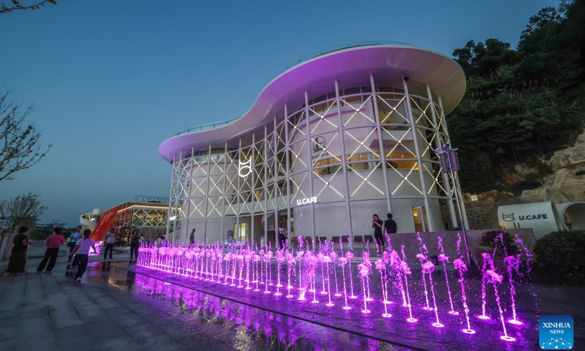 The oil tank park opened here recently, transformed from an oil depot with a history of several decades. In the park, one of two tanks has been converted into a trendy cafe, while the other tank has been developed into an island-themed cultural and creative space showcasing local specialty cultural products. Equipped with supporting facilities including convenience stores, restaurants, a waterfall viewing area, a camping zone, electric vehicle charging stations, and rest stops, the oil tank park injects new vitality into the local cultural tourism economy. (Xinhua/Xu Yu)