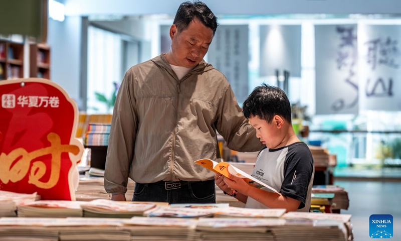 People select books at a bookstore in Kunming, southwest China's Yunnan Province, June 28, 2026. Lots of residents enjoy their leisure time immersed in books at bookstores in Kunming over the weekend. Recent years have seen the city actively expand public reading spaces to foster a strong atmosphere for reading culture. (Xinhua/Hu Chao)

