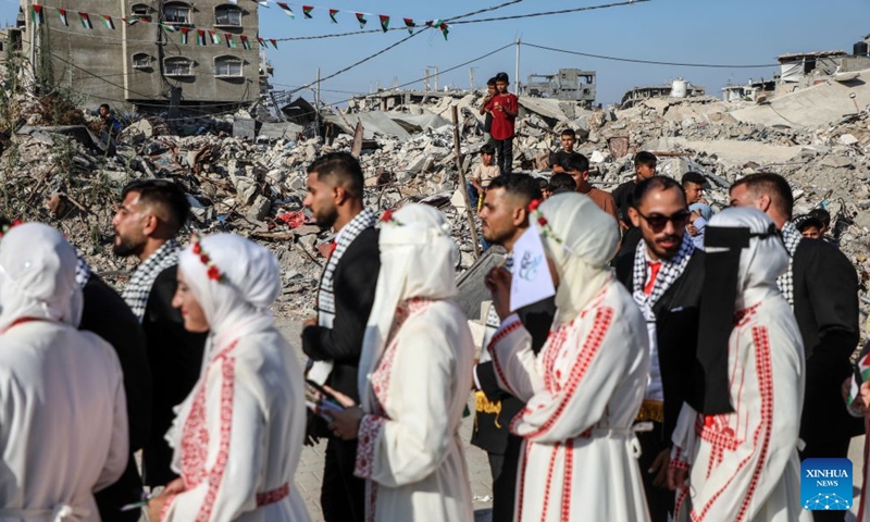 Palestinian brides and grooms participate in a group wedding in Jabalia refugee camp in the northern Gaza Strip, June 28, 2026. (Photo by Rizek Abdeljawad/Xinhua)

