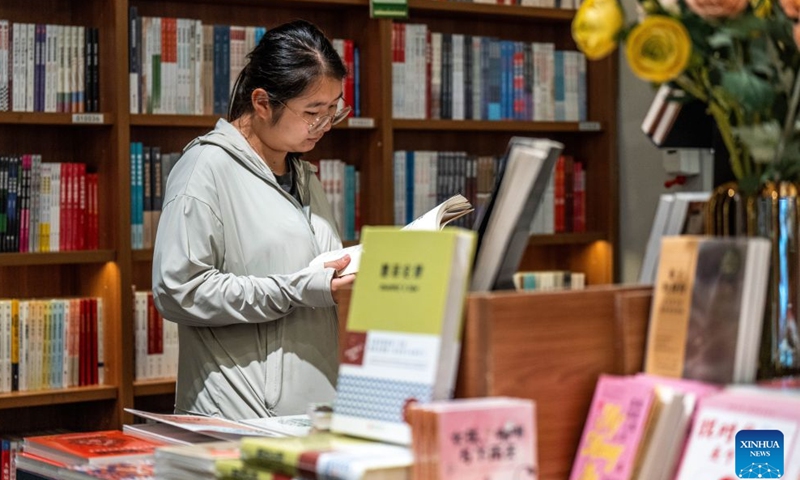 A woman reads at a bookstore in Kunming, southwest China's Yunnan Province, June 28, 2026. Lots of residents enjoy their leisure time immersed in books at bookstores in Kunming over the weekend. Recent years have seen the city actively expand public reading spaces to foster a strong atmosphere for reading culture. (Xinhua/Hu Chao)

