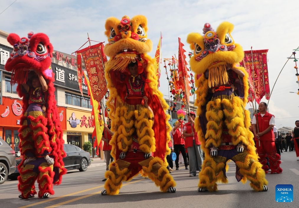 Performers stage a lion dance parade at an event themed on village flavors in Shiqian County, Tongren City, southwest China's Guizhou Province, June 27, 2026. A series of events themed on village flavors were held in Shiqian County over the weekend. More than 10 village- or community-based teams competed in cuisine contests using local ingredients such as Shiqian moss tea and seasonal produce. Parades featuring intangible cultural heritage, recreational competitions and other activities were also held to showcase local cuisine and rural traditions. (Photo by Sun Wei/Xinhua)


