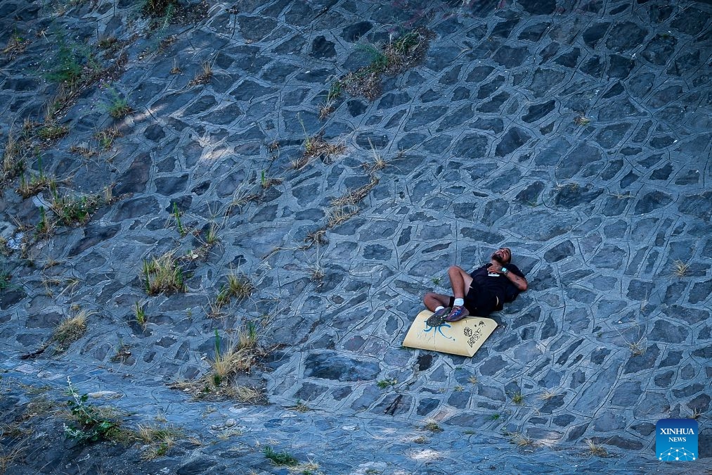 A man rests in the shade amid a heatwave in Budapest, Hungary, June 29, 2026. Hungary remains under a third-degree heat alert, the country's highest level, with temperatures forecast to reach between 35 and 40 degrees Celsius across much of the country in the coming days. (Photo: Xinhua)