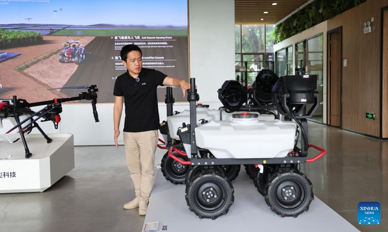 Chen Yousheng, a senior management staff member from XAG, an agritech robot maker, introduces agricultural unmanned ground vehicles (UGVs) in Guangzhou, south China's Guangdong Province, June 29, 2026. XAG, founded in 2007, is committed to empowering agriculture with robotics, artificial intelligence and new energy technologies. (Photo: Xinhua)