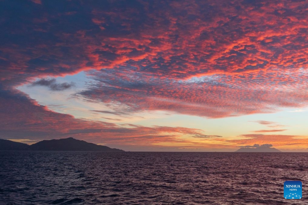 This photo shows a view of Mahe Island (L) during sunset in Seychelles, June 26, 2026. Mahe Island, the largest among all islands of the nation, is home to the capital city Victoria and a renowned tourist destination. (Photo: Xinhua)
