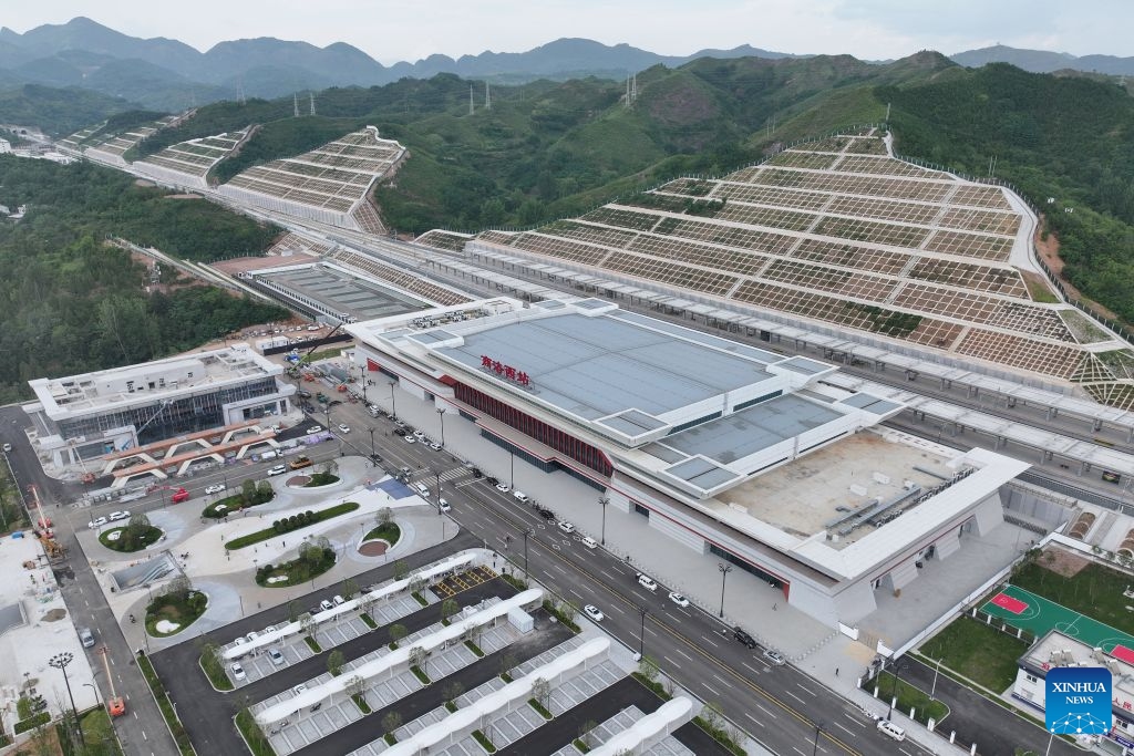 An aerial drone photo taken on June 28, 2026 shows the Shangluo West Railway Station in Shangluo City, northwest China's Shaanxi Province. The Xi'an-Shiyan high-speed railway is set to enter operation on Tuesday, cutting the fastest travel time between Xi'an, capital of northwest China's Shaanxi Province, and Wuhan, capital of central China's Hubei Province, to 2 hours and 41 minutes. It connects major tourist attractions including the Qinling Mountains and Wudang Mountain, and its operation is expected to boost local tourism. (Photo: Xinhua)