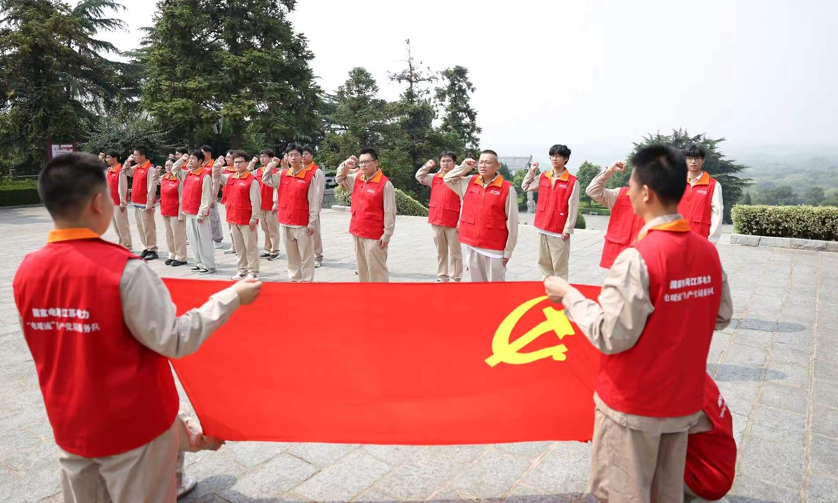 To celebrate the 105th anniversary of the CPC's founding, Party members from the volunteer service team of a State Grid power supply in Lianyungang, EasT China's Jiangsu Province renew their oaths before the Party flag, honor revolutionary martyrs and receive red education on June 29, 2026. Photo: VCG