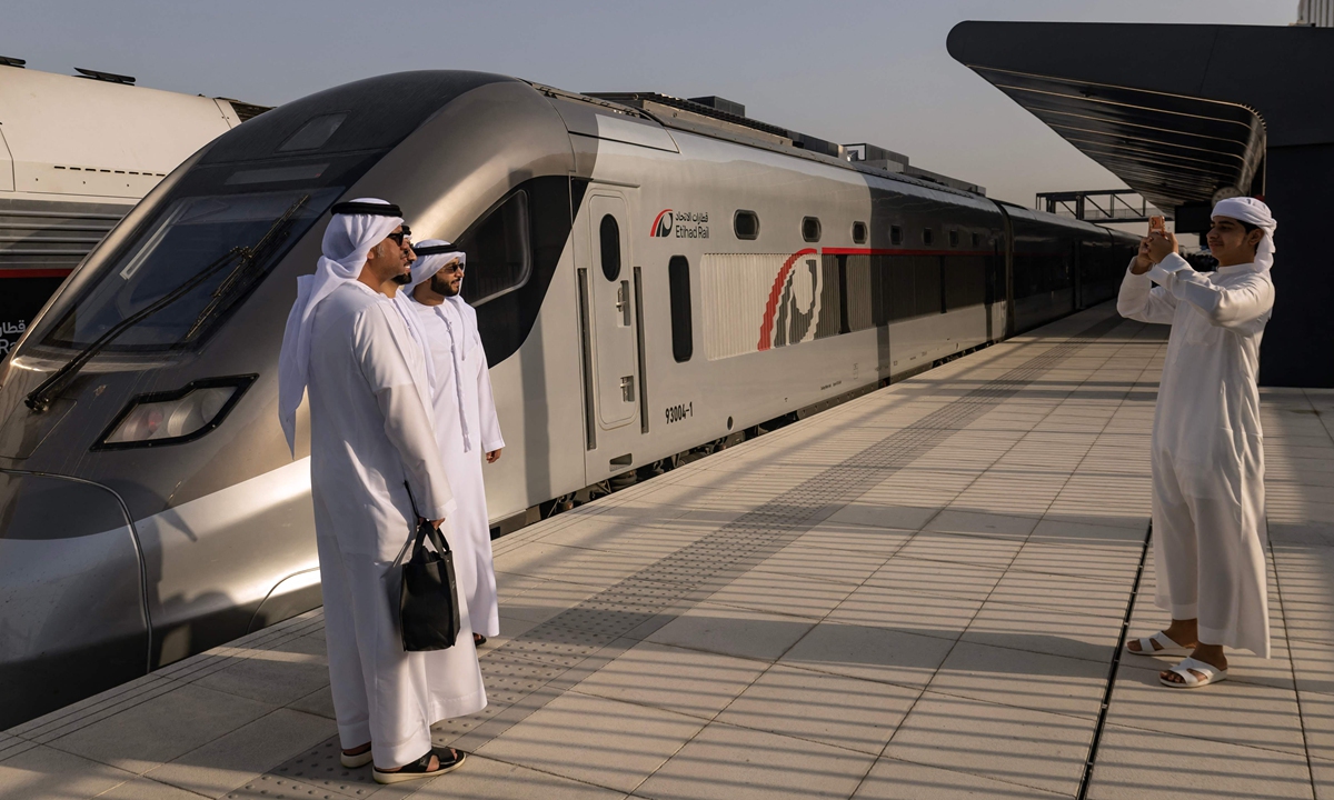 People take photos in front of the first Etihad Rail passenger train at Mohammed bin Zayed City station in Abu Dhabi, UAE, on June 30, 2026. The trial operation phase from Abu Dhabi to Fujairah began the same day, local media reported. During the construction of the railway, multiple Chinese companies participated in the project, including China Railway International and CRRC. Photo: VCG