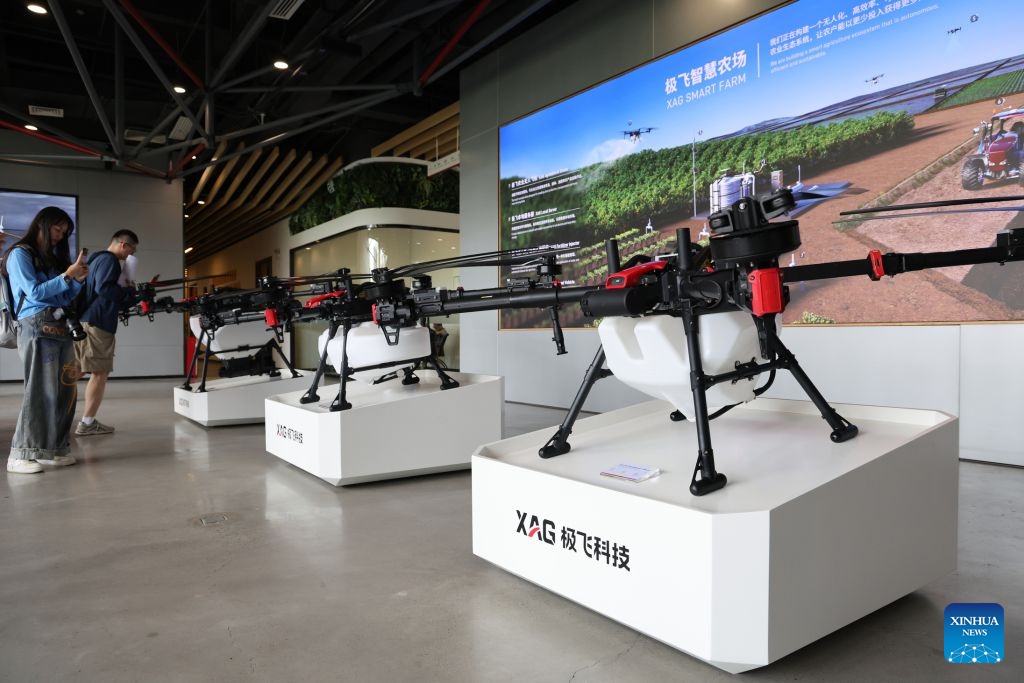 Visitors learn about agricultural drones at XAG, an agritech robot maker, in Guangzhou, south China's Guangdong Province, June 29, 2026. XAG, founded in 2007, is committed to empowering agriculture with robotics, artificial intelligence and new energy technologies. (Photo: Xinhua)