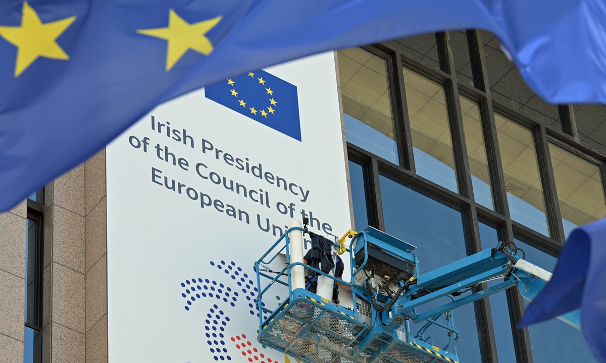 Workers hang a new banner on the Justus Lipsius Building in Brussels, Belgium, on July 1, 2026, to mark the start of Ireland's EU Council presidency. The Council presidency changes every six months, and Cyprus previously held the presidency. Photo: VCG