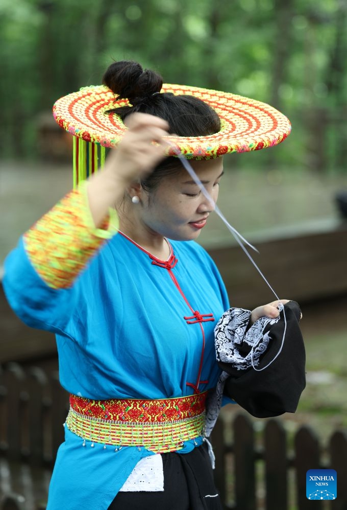 Shen Yanxi, a provincial-level inheritor of Tiaohua cross-stitch embroidery, makes Tiaohua cross-stitch embroidery in Longhui County of Shaoyang, central China's Hunan Province, June 23, 2026. Tiaohua cross-stitch embroidery is a traditional handicraft passed down through generations by women of Huayao, a branch of Yao ethnic group, in Longhui County.(Xinhua/Zhao Zhongzhi)