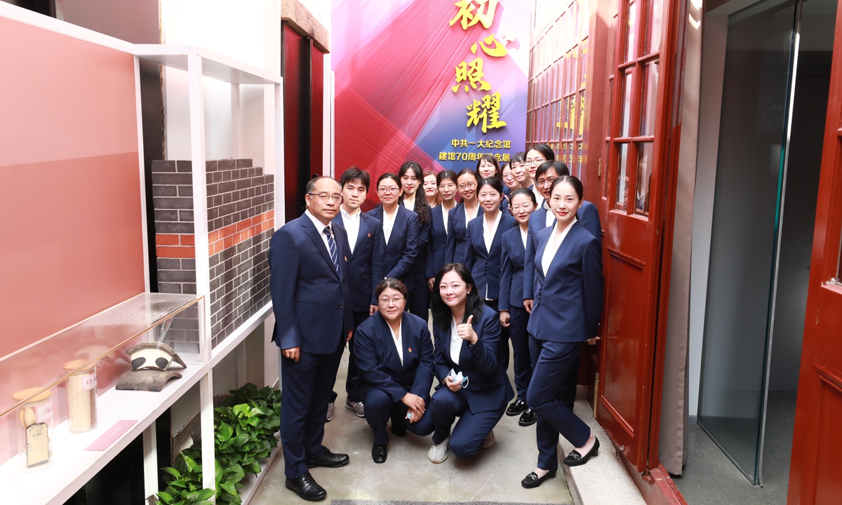 Zhang Yuhan (first from the left in the front row) poses for a photo with the staff of a themed exhibition at the Memorial Hall of the First National Congress of the CPC in Shanghai. Photo: Courtesy of Zhang