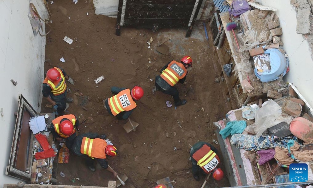 Photo taken with mobile phone shows rescuers working at the roof collapse site in Lahore, Pakistan on June 30, 2026. At least 14 children were killed and several others injured after the roof of a private tuition center collapsed in Pakistan's eastern city of Lahore on Tuesday. (Str/Xinhua)