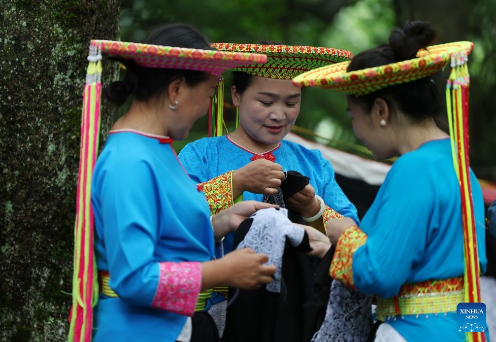 Women from Huayao branch of Yao ethnic group display Tiaohua cross-stitch embroidery skills in Longhui County of Shaoyang, central China's Hunan Province, June 23, 2026. Tiaohua cross-stitch embroidery is a traditional handicraft passed down through generations by women of Huayao, a branch of Yao ethnic group, in Longhui County.(Xinhua/Zhao Zhongzhi)