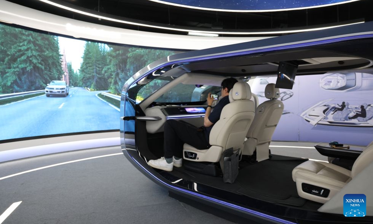 A visitor experiences a smart cabin at Desay SV, a leading smart mobility technology company, in Huizhou, south China's Guangdong Province, June 30, 2026. (Xinhua/Liang Xu)