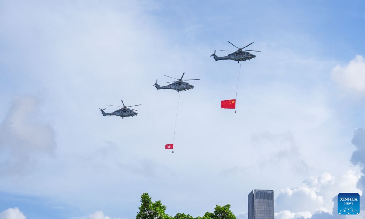Helicopters carry China's national flag and the flag of the Hong Kong Special Administrative Region (HKSAR) during a flag-raising ceremony held by the HKSAR government to celebrate the 29th anniversary of Hong Kong's return to the motherland in Hong Kong, south China, July 1, 2026. (Xinhua/Zhu Wei)