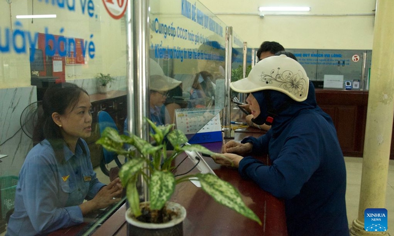 A woman inquires at the ticket office of Hanoi Station in Hanoi, Vietnam, July 1, 2026. Vietnam's railway operator will cut fares by 10 percent on North-South passenger trains from Wednesday through Aug. 16, passing on savings from falling domestic fuel prices, the Vietnam News Agency reported Wednesday. (Photo: Xinhua)